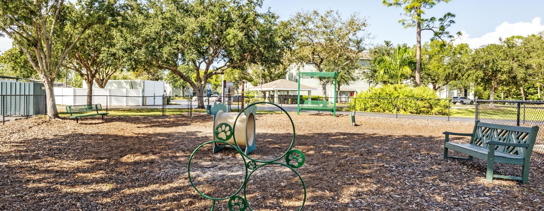 a playground with a bench and a bike rack
