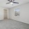 One-Bedroom Apartments in North Naples, FL - Meadow Brook Preserve - Bedroom with Carpeted Flooring, Ceiling Fan, Spacious Closet, and Large Window.