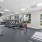 Fitness Center3-Bedroom Apartments in North Naples, FL - Meadow Brook Preserve - Fitness Center with Stationary Bike, Elliptical Machine, Treadmills, Mirror Wall, and Large Windows.